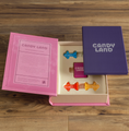 Load image into Gallery viewer, An open look at the Candy Land board game box with game pieces shown.