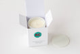 Load image into Gallery viewer, A white jar candle in an open white box with the lid placed beside it on a clean white background. The box has a green circular logo with red letters and the text 'KC' and 'SIGNATURE CANDLE'.