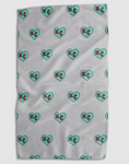 Load image into Gallery viewer, A white textured blanket featuring a repeating pattern of mint green hearts with red 'KC' initials inside, shown flat against a light gray background.