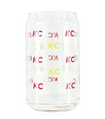 Load image into Gallery viewer, A clear glass can-shaped tumbler with repeating red and yellow 'KC' lettering, shown on a plain white background.