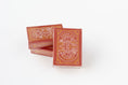 Load image into Gallery viewer, Three red playing card decks with gold Kansas City skyline designs, standing on a white background.