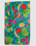 Load image into Gallery viewer, A rectangular kitchen towel or cloth featuring a colorful vegetable print on a turquoise blue background, shown flat against a light gray backdrop.

