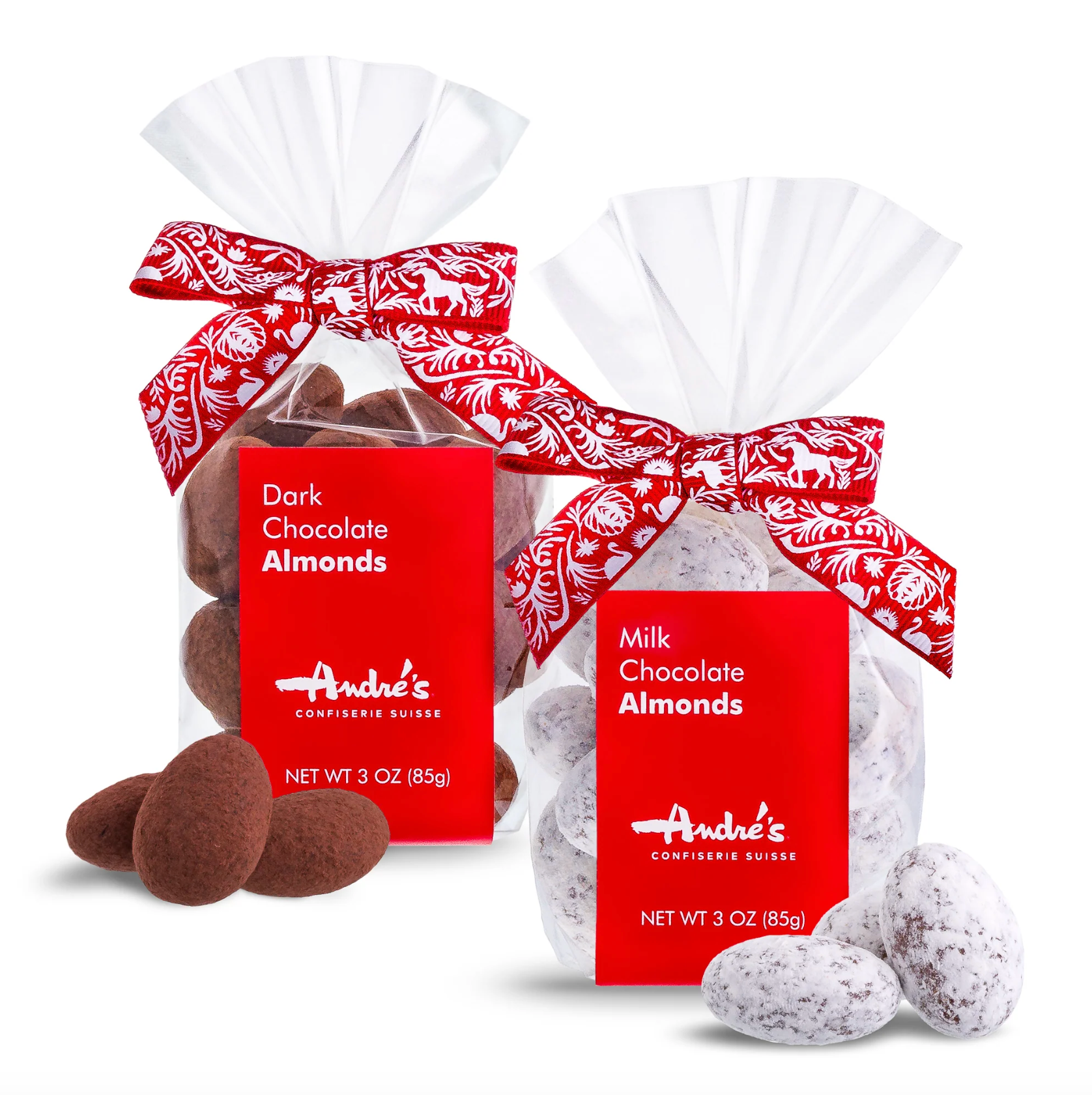 Two 3 oz bags of Andre's Confectionery chocolates, one with dark chocolate almonds and one with milk chocolate almonds, both in clear bags with red labels and white ribbon bows, shown on a white background with loose almonds in front.