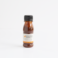 Load image into Gallery viewer, A small bottle of Jack Stack Barbecue Kansas City Original sauce, filled with dark reddish-brown sauce and topped with a black cap, centered on a clean white background.
