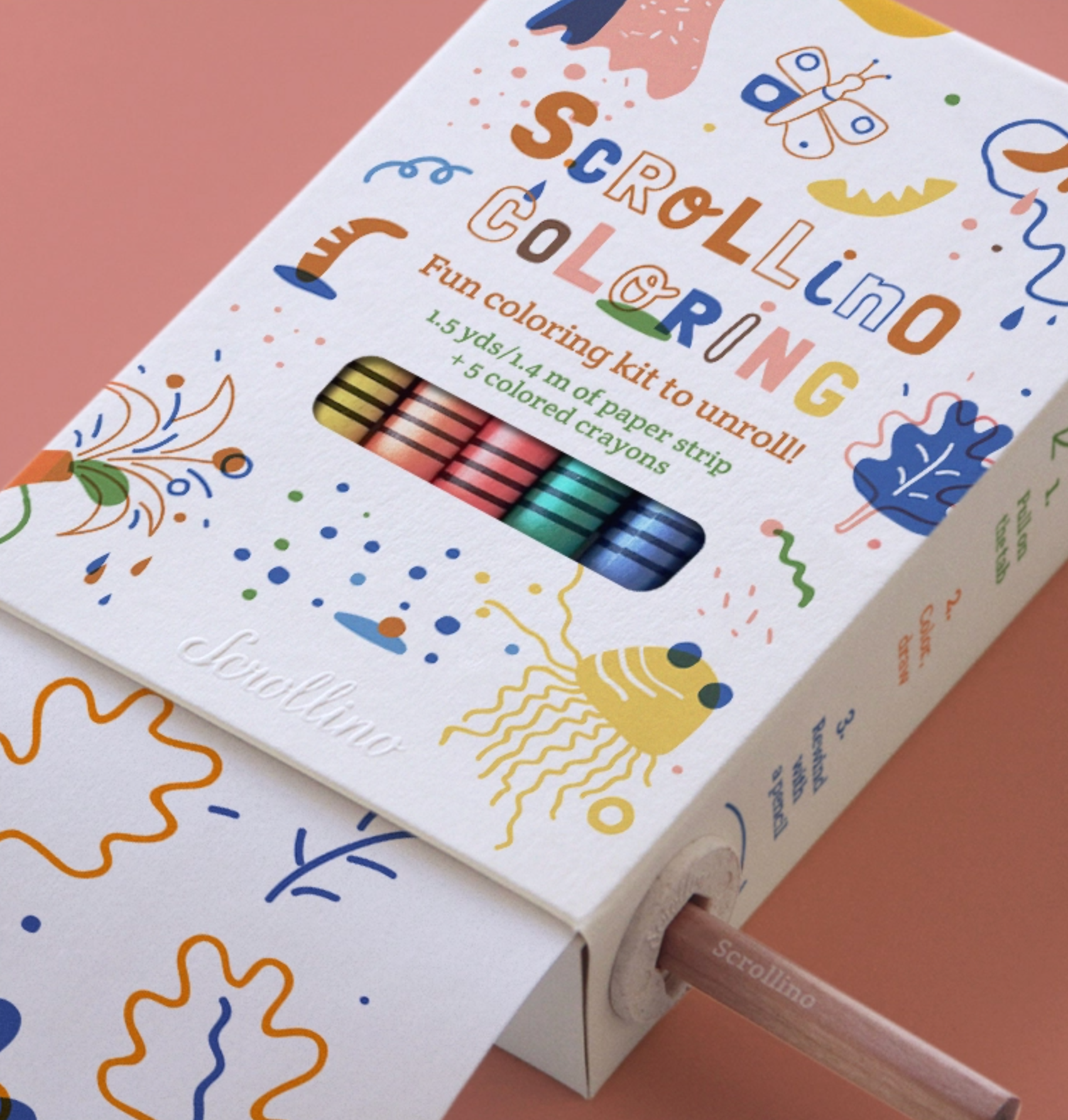 A close up shot on scrollino coloring book, filled with crayons and 1.5yds of paper to color on. 