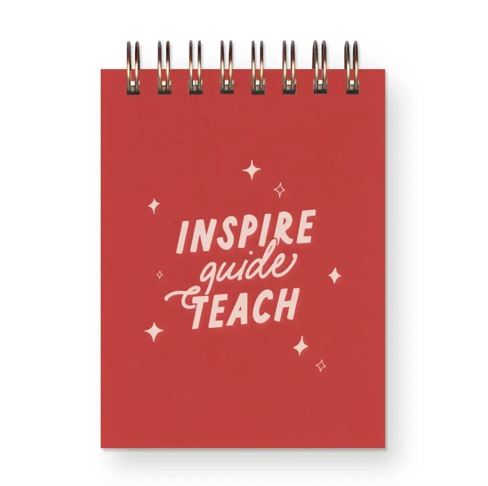 A small spiral-bound notepad in red with the words "Inspire, Guide, Teach" on the cover